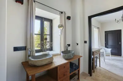 a bathroom with a large sink and a mirror at Five-Bedroom Estate Above Ménerbes Village in Ménerbes