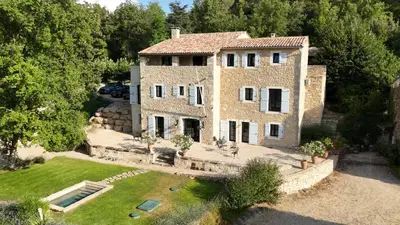 an aerial view of a large brick house with a yard at Five-Bedroom Estate Above Ménerbes Village in Ménerbes