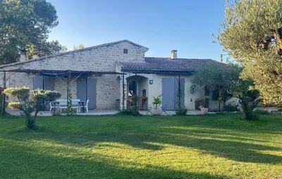 a stone house with a yard with a lawn sidx sidx at Pet Friendly Home In Caromb in Caromb