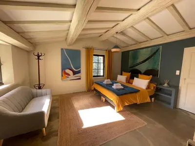 a living room with a bed and a couch at L'ISLE SUR LA SORGUE - Maison de prestige in Saumane-de-Vaucluse