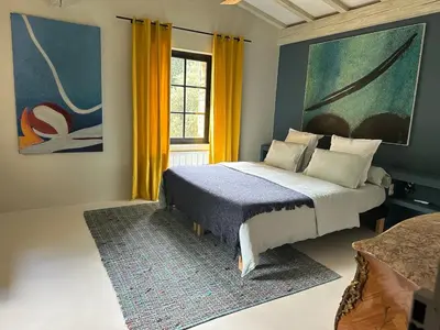 a bedroom with a bed and a large window at L'ISLE SUR LA SORGUE - Maison de prestige in Saumane-de-Vaucluse