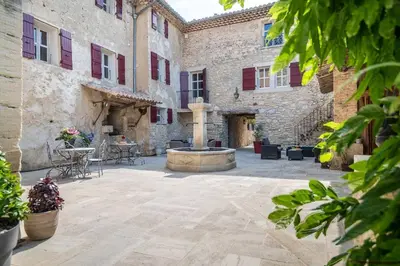 a courtyard with a fountain in a building at Wine Estate With Sunset Courtyard Near Bédoin in Mazan