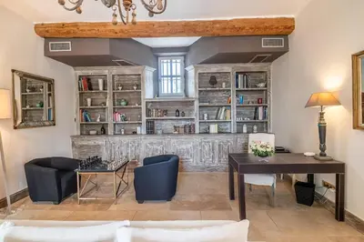 a living room with a desk and a book shelf at Wine Estate With Sunset Courtyard Near Bédoin in Mazan