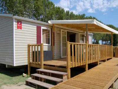 a tiny house with a porch and a deck at Mobil Home PMR avec Terrasse à Cavaillon - API-1-52-1378 in Cavaillon
