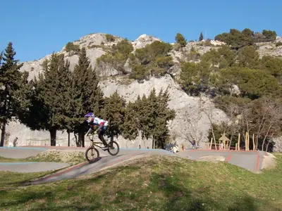a person riding a bike on a road at Mobil-home confortable, 2 chambres, 4 personnes - API-1-52-1390 in Cavaillon