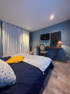 a bedroom with a bed and a desk with a computer at Splendid Loft in Provence in Robion en Luberon