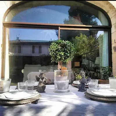 a table with plates and glasses on top of it at Splendid Loft in Provence in Robion en Luberon