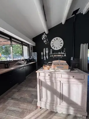 a kitchen with a large clock on the wall at Splendid Loft in Provence in Robion en Luberon