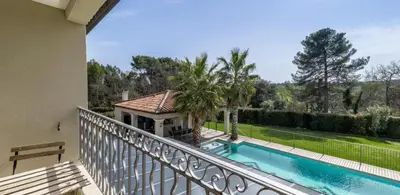 a balcony with a view of a swimming pool at Villa Peyriere-Ventoux in Carpentras