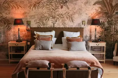 a bedroom with a large bed with two tables and two lamps at 19Th-Century Mas With Pool And Garden Facing Luberon in Oppède