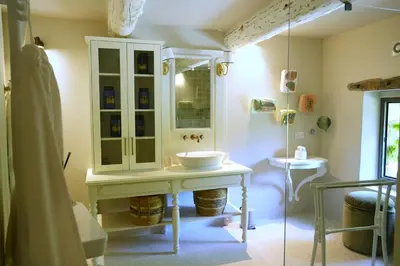 a bathroom with a sink and a mirror at 19Th-Century Mas With Pool And Garden Facing Luberon in Oppède