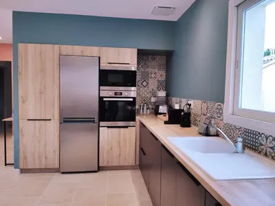 a kitchen with a stainless steel refrigerator and a sink at New Villa in Provence La Modèna in Modène