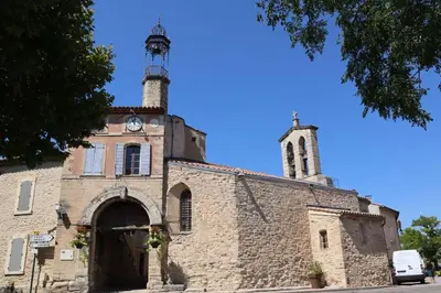 an old stone church with a clock tower on it at New Villa in Provence La Modèna in Modène