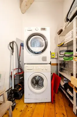 a washer and dryer sitting in a laundry room at Charmante maison de village avec cour intérieure in Bédoin