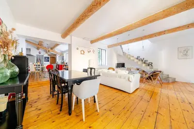 a large living room with a table and chairs at Charmante maison de village avec cour intérieure in Bédoin
