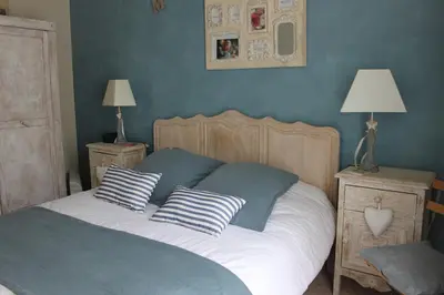 a bedroom with a bed with two pillows on it at Rooms with sculptor in Pinèdes in Aurons