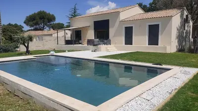 a swimming pool in front of a house at Villa la grande Bastide in Oppède