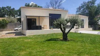 a small tree in a yard in front of a house at Villa la grande Bastide in Oppède