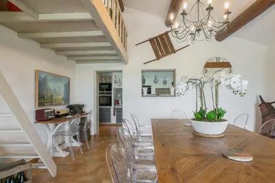 a dining room with a wooden table and chairs at Bastide Vallonia Luxury & Serenity in the Heart of the Luberon in Murs