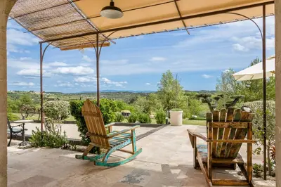 two chairs and a table on a patio with a view at Bastide Vallonia Luxury & Serenity in the Heart of the Luberon in Murs