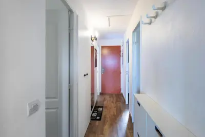 a hallway with white walls and a red door at Village Pont Royal en Provence - maeva Home - Appartement climatisé 4 pièces 6 personnes - Sélection - super Home MAE-7473 in Mallemort