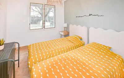 a living room with a bed and a window at Maison Avec Piscine Privée in Mazan