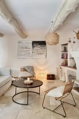 a living room with a couch and a table at Artist's House In The Heart Of Lourmarin in Lourmarin