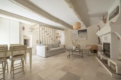 a living room with a couch and a table at Artist's House In The Heart Of Lourmarin in Lourmarin