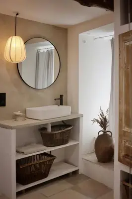 a bathroom with a sink and a mirror at Artist's House In The Heart Of Lourmarin in Lourmarin