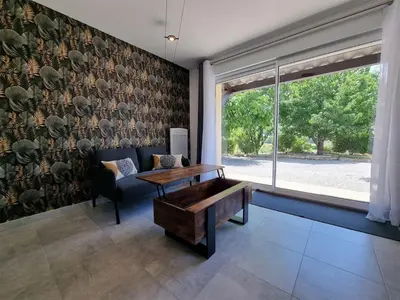 a living room with a couch and a table at Gîtes de la Coupière Le Mûrier in Aubenas-les-Alpes