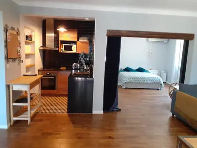 a kitchen with a refrigerator and a bed in a room at Gîte de la Transhumance - 80m2 in Rognes