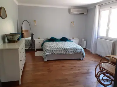 a bedroom with a bed and a dresser and a mirror at Gîte de la Transhumance - 80m2 in Rognes