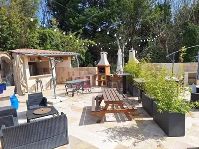 a patio with chairs and a table and a grill at Apartment Gîte Moulin de Tartay by Interhome in Avignon