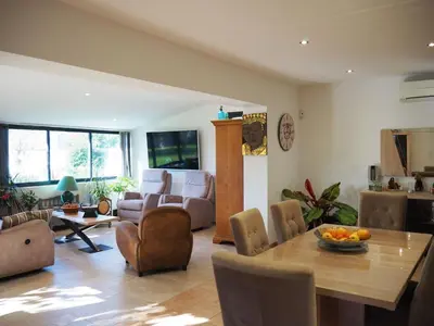 a living room with a table and a couch at Holiday Home by Interhome in Vernègues