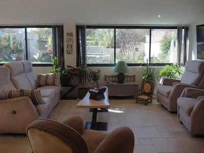 a living room with couches and tables and windows at Holiday Home by Interhome in Vernègues