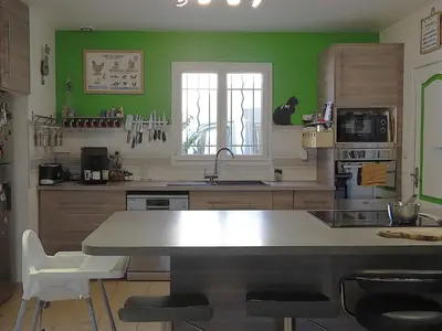 a kitchen with green walls and a large counter top at Holiday Home by Interhome in Vernègues