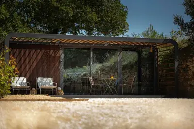 a pavilion with chairs and a table in it at Sous les étoiles du Luberon, Tiny House, Ménerbes in Ménerbes