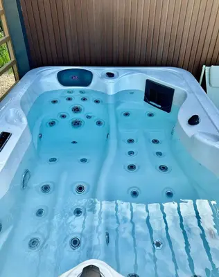 a jacuzzi tub in a room with a sink at Sous les étoiles du Luberon, Tiny House, Ménerbes in Ménerbes