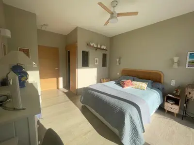 a bedroom with a bed and a ceiling fan at 1 Brin à part in Maubec