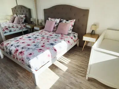 a bedroom with a large bed with pink pillows at Appartement Spacieux avec Balcon in Carpentras