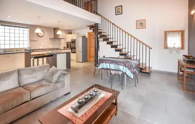 a living room with a couch and a table at Maison Avec Piscine 1 in Mormoiron