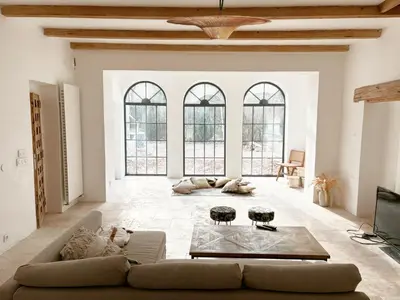 a living room with a couch and a table at Le Mas des Poètes in Saint-Andiol