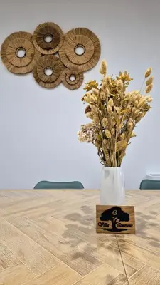 a vase with flowers in it sitting on a table at Villa Quercus Design Piscine et Loisirs in Ménerbes