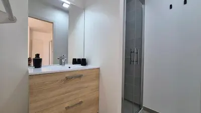 a bathroom with a sink and a mirror at Villa Quercus Design Piscine et Loisirs in Ménerbes