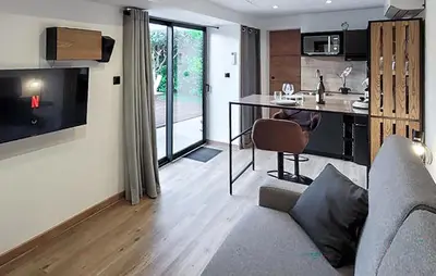 a living room with a couch and a kitchen with a table at Nice Home In Jonquerettes in Jonquerettes