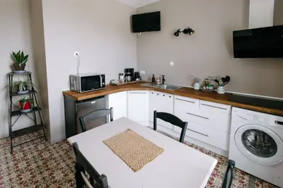 a kitchen with a table and a washing machine at 