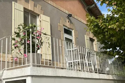 a balcony with chairs and flowers on a building at 