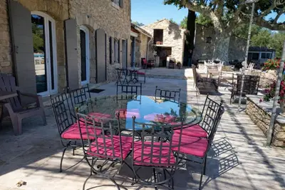 a bedroom with a large bed and two lamps at Villa Ulysse - Tennis court and private pool in LʼIsle-sur-la-Sorgue