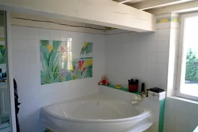 a bedroom with a bed and a table with a lamp at Villa Ulysse - Tennis court and private pool in LʼIsle-sur-la-Sorgue
