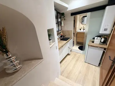 a kitchen with white cabinets and a sink at Aix-en-Provence - studio plein centre ville refait à neuf avec climatisation in Aix-en-Provence